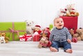 Christmas and birthday - cute baby sitting barefoot and looking Royalty Free Stock Photo