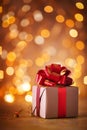 Christmas or Birthday gift box with red ribbon against golden lights bokeh background. Holiday greeting card Royalty Free Stock Photo