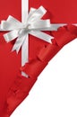 Christmas Or Birthday White Satin Gift Ribbon Bow On Torn Open Red Paper Background
