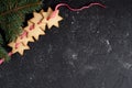Christmas black background with cookies and fir branch