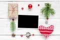 Christmas blank photo card in frame made of fir tree branches, decorations and gift boxes Royalty Free Stock Photo