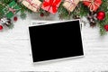 Christmas blank photo frame with fir tree branches, decorations and gift boxes Royalty Free Stock Photo