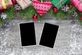 Christmas blank photo frames with fir tree branches, decorations, gift boxes and knitted heart Royalty Free Stock Photo