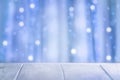 Christmas blue background. Blurred background of wooden boards and abstract background of shiny bokeh lights for a holiday party Royalty Free Stock Photo