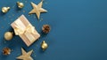 Christmas blue background with a border of gift box, golden stars and balls, confetti. Flat lay, top view, copy space. Xmas banner Royalty Free Stock Photo