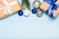 Christmas blue background with decorations, gift box and fir branches top view Royalty Free Stock Photo