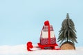 Christmas blue background with gift boxes on red sled and christmas tree. copy space Royalty Free Stock Photo