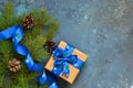 Christmas blue background with gift boxes and xmas tree. Royalty Free Stock Photo