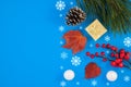 Merry Christmas and Happy Holidays greeting card, frame, banner, pine cone and decorative snowballs on blue background, top view. Royalty Free Stock Photo