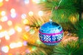 Christmas blue ball on a Christmas tree on a background of lights garlands, bokeh.