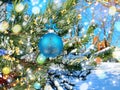 Christmas blue   ball on green tree and confetti illumination blurred light holiday background greetings card Royalty Free Stock Photo