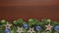 Christmas blue green decor with chocolate wooden background