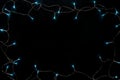 Christmas blue lights frame on black background. Royalty Free Stock Photo