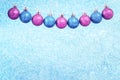 Christmas baubles garland on light blue glitter background Royalty Free Stock Photo