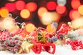 Christmas bokeh background with Santa sleigh, gold gift, red holly berries and colorful Xmas decoration on white winter snow Royalty Free Stock Photo