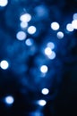 Abstract pattern of blue bokeh lights on a dark background Royalty Free Stock Photo