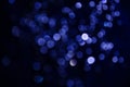 Abstract pattern of blue bokeh lights on a dark background Royalty Free Stock Photo