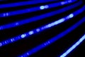 Bokeh blue abstract background with blurred neon light curved lines Royalty Free Stock Photo