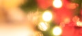 Christmas bokeh blur background with blurry xÃ¢â¬â¢mas tree party night light decoration ornate in warm red green gold color Royalty Free Stock Photo