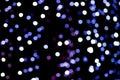 Christmas bokeh overlay background. Blue and violet lights on the black background. New Year, festive atmosphere Royalty Free Stock Photo