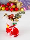 christmas boot stocking filled gifts ,sprig Christmas tree holly and lollipop stick Royalty Free Stock Photo