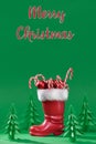 Christmas boot stocking with gifts on a green background. Happy Christmas. Royalty Free Stock Photo