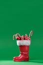 Christmas boot stocking with gifts on a green background. Happy Christmas. Royalty Free Stock Photo