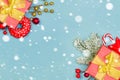Christmas border background. Red gifts, holly berries and green  with snow Royalty Free Stock Photo