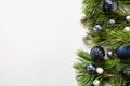 Christmas border with blue balls, evergreen branches on white. Xmas greeting card Royalty Free Stock Photo