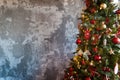 Christmas border branches of fir tree with decoration and grey concrete wall Royalty Free Stock Photo