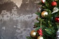 Christmas border branches of fir tree with decoration and grey concrete wall Royalty Free Stock Photo