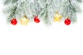 Christmas border composition with red glass baubles, gold stars, holly berries and green fir branch isolated on white background. Royalty Free Stock Photo