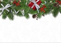 Christmas border branches and holly on white background Royalty Free Stock Photo