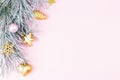 Christmas border with fir branches, conifer cones, christmas balls and golden christmas ornaments on pastel background Royalty Free Stock Photo