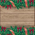 Christmas border with fir branches, accessories, ribbons and stars. Vector illustration on realistic wooden background