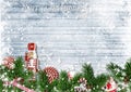 Christmas border with fir branches, nutcracker, candy and snowfall Royalty Free Stock Photo