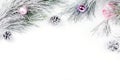 Christmas border with fir branches, presents, christmas ornaments on white background Royalty Free Stock Photo
