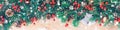 Christmas border with fir branches, red holly berries, cones and snowflakes on wooden background Royalty Free Stock Photo