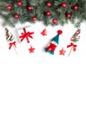 Christmas border with fir branches, snowman, lollipops and Christmas decorations on a white background. View from above. Copy Royalty Free Stock Photo