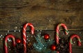 Christmas border with fir tree branches, cones, christmas decorations and candy cane on wooden boards Royalty Free Stock Photo