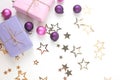Christmas gift boxes with golden stars, pink and purple decorations on white background. Royalty Free Stock Photo