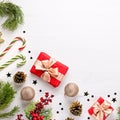 Christmas border flat lay with pine, presents, golden elements, candy canes, confetti. Christmas template on light wood Royalty Free Stock Photo