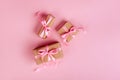 Christmas border with gift boxes, balls, decoration and sequins on pink table top view. Royalty Free Stock Photo