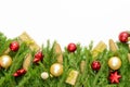 Christmas border isolated on white, composed of fresh fir branches, cones and ornaments in red and gold Royalty Free Stock Photo
