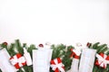 Christmas border made of fir branches, gifts, medical masks and antiseptic on a white background. Royalty Free Stock Photo