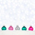 Christmas border of pastel ornaments in snow with twinkling lights Royalty Free Stock Photo