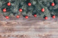 Christmas border with red baubles and fir branches on a wooden background. Happy new year. Greeting card. Copy space, top view, Royalty Free Stock Photo