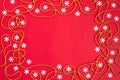 Christmas border with snowflakes and gold garland on red background. Happy new year. Space for text. Winter concept Royalty Free Stock Photo