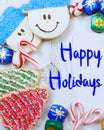 Christmas border of sweets, including cookies, peppermints and chocolates on a rustic wooden background.