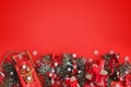 Christmas border of toys, gift box, ribbons and snowflakes on red background Royalty Free Stock Photo